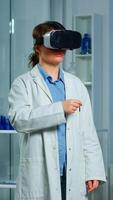 Professional researcher wearing virtual reality glasses using medical inovation in lab analysing brain scan of patient. Team of neurological doctors working with equipment high tech simulator device photo