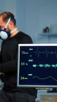 Team of medial researchers monitoring vo2 of man performance sports wearing mask running. Lab science doctor measuring endurance of sportsman while ekg scan runs on computer screen in laboratory photo