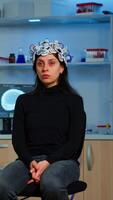 Researcher and patient with eeg headset looking at virtual display with touchscreen, virtual reality using medical inovation in neurological research lab. Scientists working with healthcare simulator photo