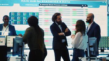 Staff members from a business enterprise discussing details and progress in a new project during a corporate meeting. Company experts getting informed about marketing developments. Camera A. photo