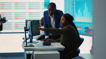 Business associates evaluating key performance indicators within the company, conducting evaluations and discussing workflow situation. Workers enhancing productivity and efficiency. Camera A. photo