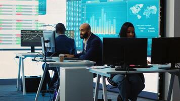 Forecast affiliates working in coworking space office to review latest business news based on performance metrics and progress. Consultants fight to expand the enterprise globally. Camera A. photo