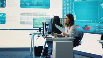 Business specialist reviewing key performance indicators within the firm activity. Conducting evaluations in order to help with global corporation expansion, enhance team efficiency. Camera A. photo