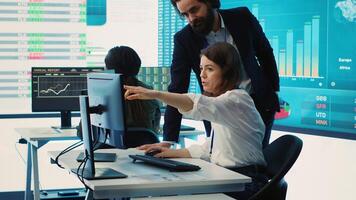 Enterprise colleagues reviewing project updates and details in monitoring room, establishing budget and other resources to achieve strategic business goals. Multiple corporation operations. camera A. photo