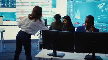 Business administrator discussing with the investors on phone call, reviewing key performance indicators during annual analysis. Manager works on data management, enterprise workflow. Camera B. photo