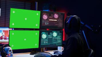 Happy man writing code on green screen PC, celebrating after managing to get past security systems. Joyous hacker feeling proud after breaching firewall using mockup computer, camera B photo