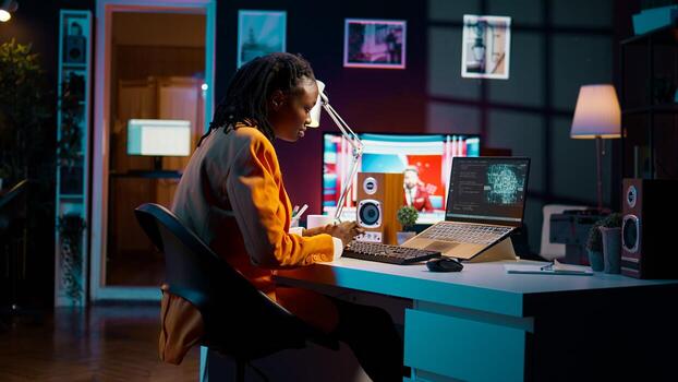 African american girl uses artificial intelligence software for machine learning and cloud computing, terminal window programming language. IT student studying deep learning AI hardware. Camera B. photo