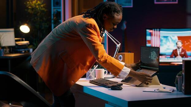 African american girl studying servers providing AI computing resources, learning to program html scripts on artificial intelligence neural network system. Woman uses coding language. Camera A. photo
