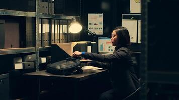 Private agent initiates background checks on individuals associated with archived cases to gather relevant information. After reading legal statements, leaving for field work. Camera A. photo
