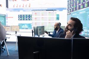 Management associate sharing insight on annual statistics during a call with the advisory board, providing initiatives to enhance operational performance metrics. Big data on a screen. photo