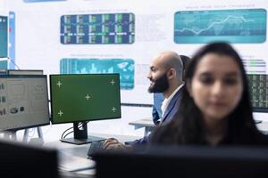 Enterprise worker examining annual sales statistics next to green screen, learning what to improve for business international development. Analyst reviewing key performance indicators. photo