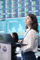 Business manager collecting important key performance indicators data for investors, transmitting organizational progress in order to expand the corporation internationally. Big screen. photo