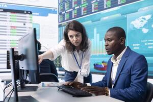 Business associates evaluating key performance indicators within the company, conducting evaluations and discussing workflow situation. Workers enhancing productivity and efficiency. photo