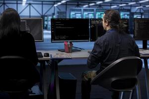 IT professionals in server hub establishment ensuring data remains shielded from potential threats. Teamworking colleagues safeguarding data center against unauthorized access photo
