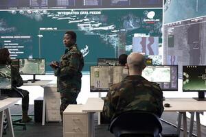 Female master sergeant gathers battlefield intelligence reports on a big screen, creating new plans for secret war operations. Reconnaissance division ensuring national safety in army power base. photo