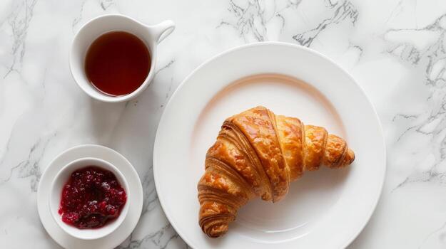 Top-View Breakfast Composition. Croissant with Raspberry Jam and Tea Set on Marble Background photo