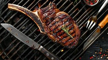 Top-View Angus Beef Tomahawk Steak on BBQ Grill with Utensils photo