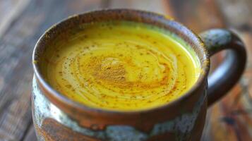 Rustic Mug of Golden Milk with Swirls of Turmeric and Honey photo