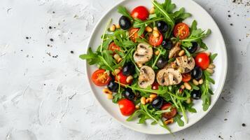 Circular Salad Composition with Arugula, Cherry Tomatoes, and Pine Nuts on White Plate photo
