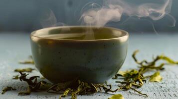 Steaming Cup of Green Tea on Gray Surface photo