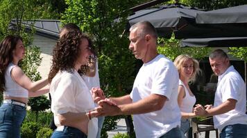 Hobby dance school Identical movements in dance, synchronicity, three couples dancing Latin American dances in the park on the street, people of different ages relaxing on a day off video