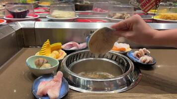 Cooking fish soup, fish soup broth with a fish head is boiling in a saucepan. Slow motion video