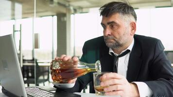 Senior businessman drinking from stress in office video