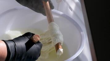 mozzarella in hand. final steps of making a cheese. Italian hard cheese silano or caciocavallo, mozzarella. video