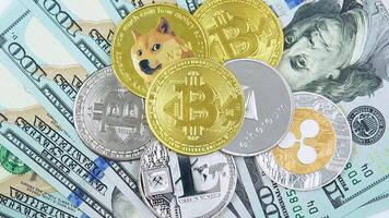 A hand putting an Bitcoin coin on a pile of different cryptocurrency coins. Digital coin cyberspace and cryptocurrency video