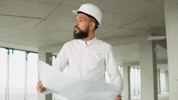 Engineer builder at construction site with blueprint video