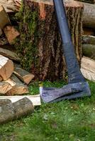 Axe in log. Axe for chopping firewood. Garden tool. photo