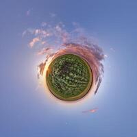 simple tiny planet without buildings in blue sky with beautiful clouds. Transformation of spherical panorama 360 degrees. Spherical abstract aerial view. Curvature of space. photo