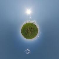 simple tiny planet without buildings in blue sky with beautiful clouds. Transformation of spherical panorama 360 degrees. Spherical abstract aerial view. Curvature of space. photo