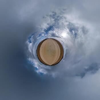 simple tiny planet without buildings in blue sky with beautiful clouds. Transformation of spherical panorama 360 degrees. Spherical abstract aerial view. Curvature of space. photo
