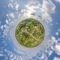 simple tiny planet without buildings in blue sky with beautiful clouds. Transformation of spherical panorama 360 degrees. Spherical abstract aerial view. Curvature of space. photo