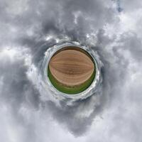 simple tiny planet without buildings in blue sky with beautiful clouds. Transformation of spherical panorama 360 degrees. Spherical abstract aerial view. Curvature of space. photo