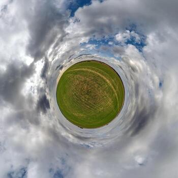 simple tiny planet without buildings in blue sky with beautiful clouds. Transformation of spherical panorama 360 degrees. Spherical abstract aerial view. Curvature of space. photo