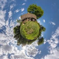 simple tiny planet without buildings in blue sky with beautiful clouds. Transformation of spherical panorama 360 degrees. Spherical abstract aerial view. Curvature of space. photo