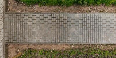top view of the texture of paving slabs on pedestrian path photo