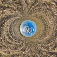 blue hole sphere little planet inside sand or dry grass round frame background photo