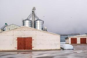 silos on agro-industrial complex with seed cleaning and drying line for grain storage photo