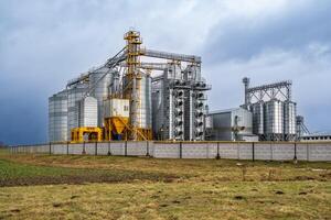 silos on agro-industrial complex with seed cleaning and drying line for grain storage photo
