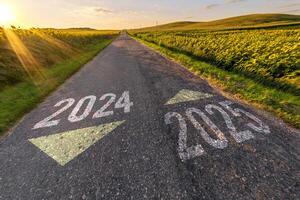 numbers 2024, 2025 on asphalt road highway with sunrise or sunset sky background. concept of destination in future, freedom, work start, run, planning, challenge, target, new year photo