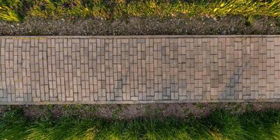 top view of the texture of paving slabs on pedestrian path photo