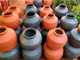 A clay water pot earthen pot for water storage Clay pots not only cool the water down, they also provide healing with the elements of earth. photo