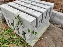 Block of cement parts built from mold for creating footpath border photo