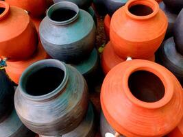 A clay water pot earthen pot with tap for water storage Clay pots not only cool the water down, they also provide healing with the elements of earth. photo