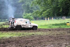 Malpas in Cheshire in the UK in September 2020. A view of a Landrover going through the mud in a field photo