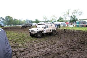 Malpas in Cheshire in the UK in September 2020. A view of a Landrover going through the mud in a field photo