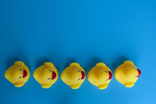 Top view of rubber ducks in line with customizable space for text photo